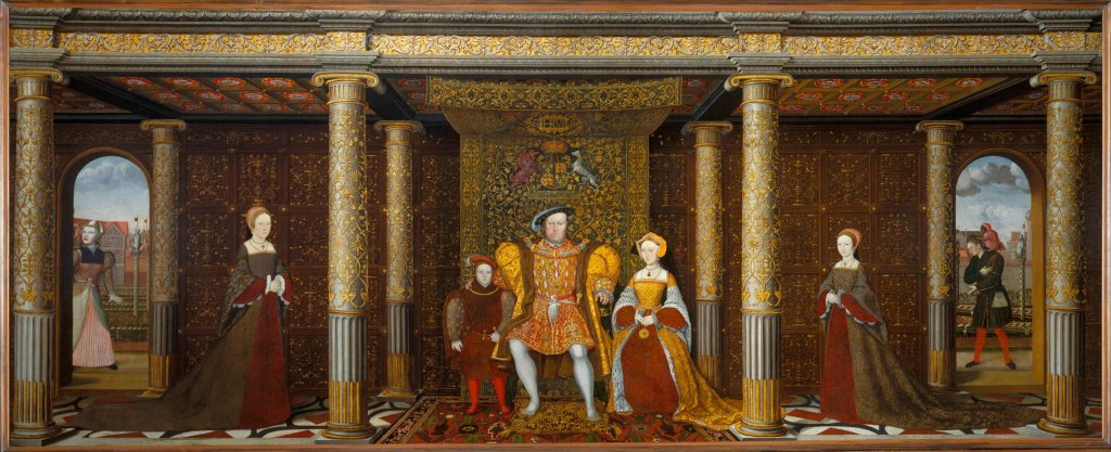 A wide portrait of the Tudor family. Henry VIII sits in the middle, with Edward at his right hand and Jane Seymour at his left. Mary stands at the far left and Elizabeth at the far right. The family are depicted in a highly decorated interior with fancy pillars.